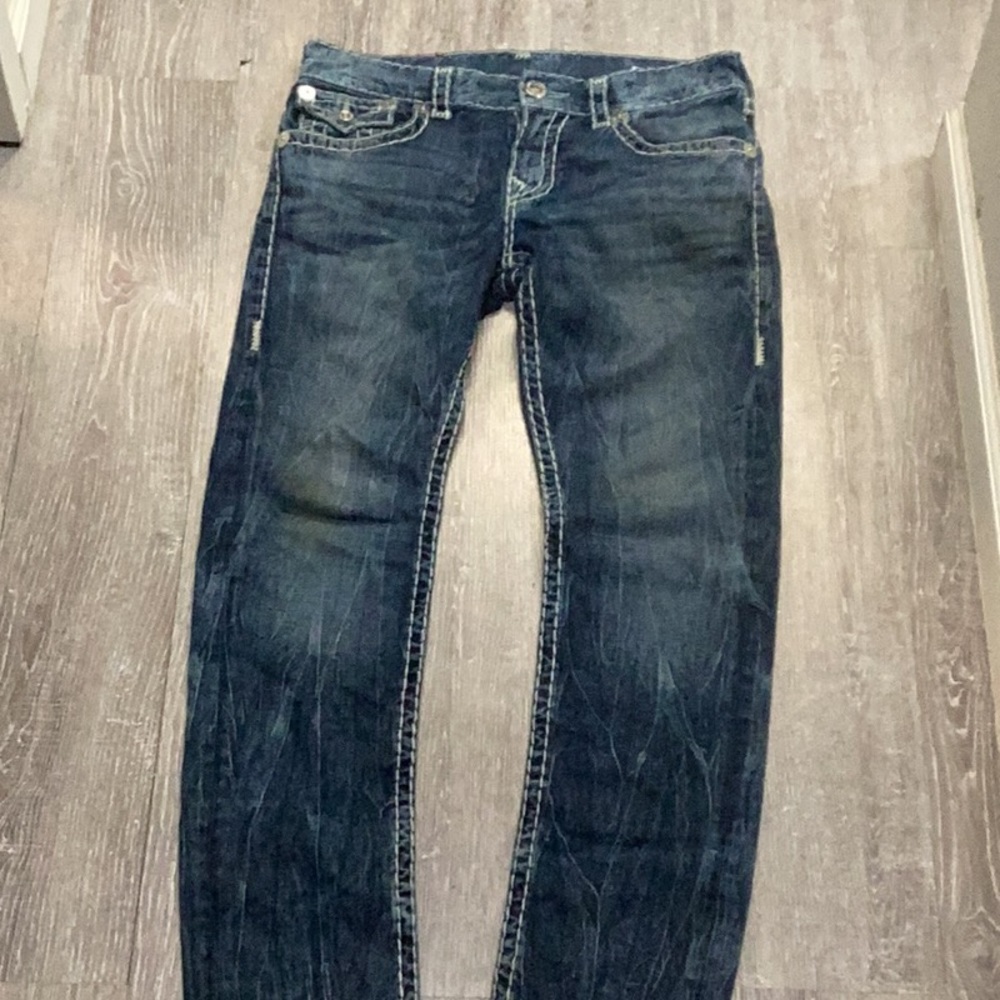 Distressed True Religion Blue jeans.